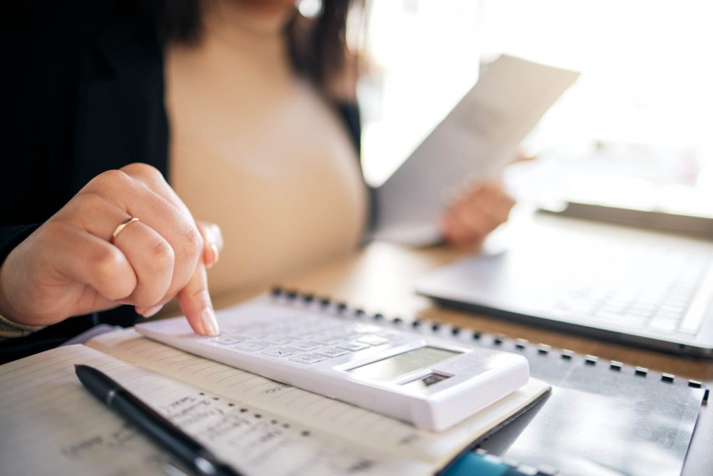 Hands, calculator and accountant working with documents, financi